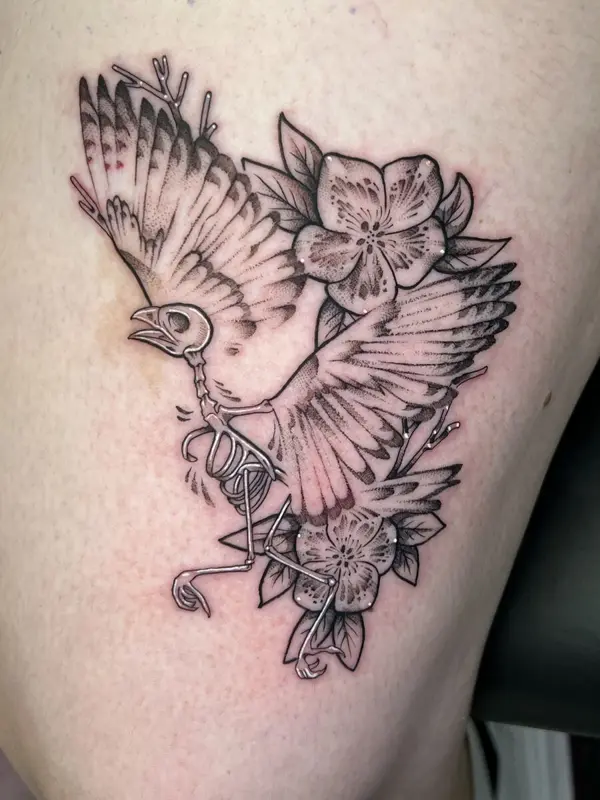 Skeleton bird in flight with cherry blossoms