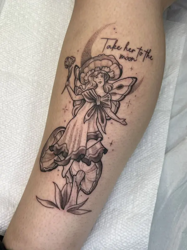 Mushroom fairy tattoo with 'take her to the moon' script, leg
