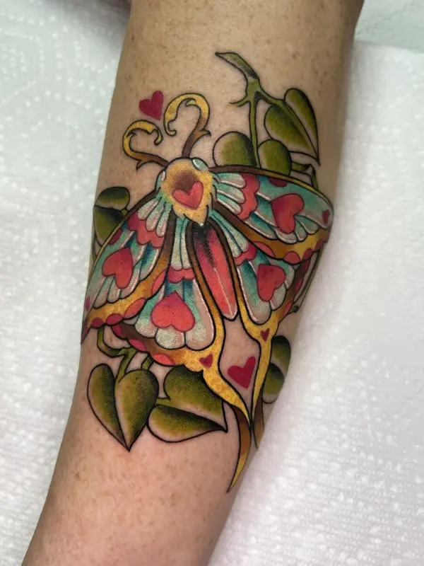 Full color luna moth tattoo with heart patterns